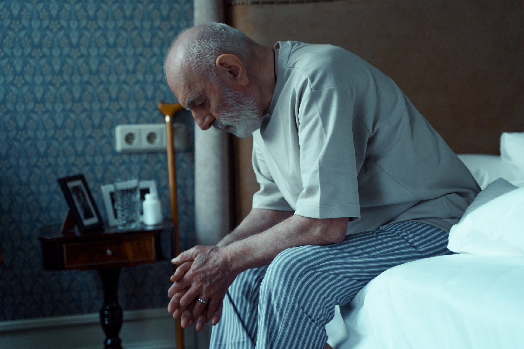 Elderly Man Sitting on Bed